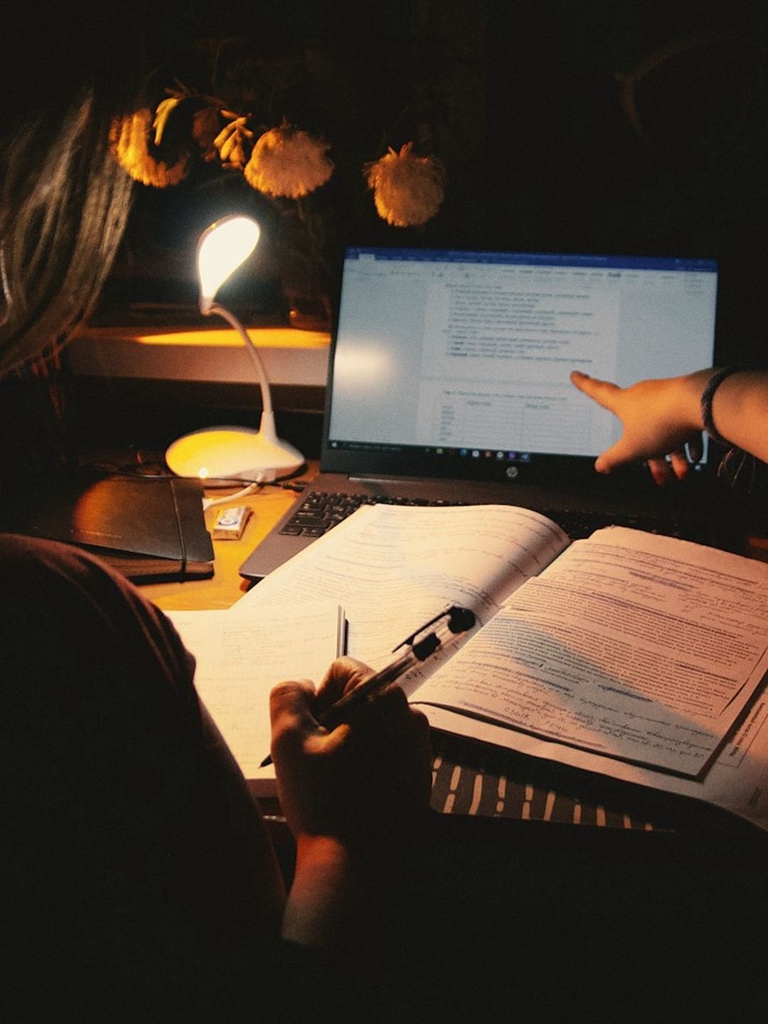 Back camera: homework under a desk lamp late at night